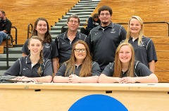 Cash with his student assistant crew during a George Fox women’s volleyball match.